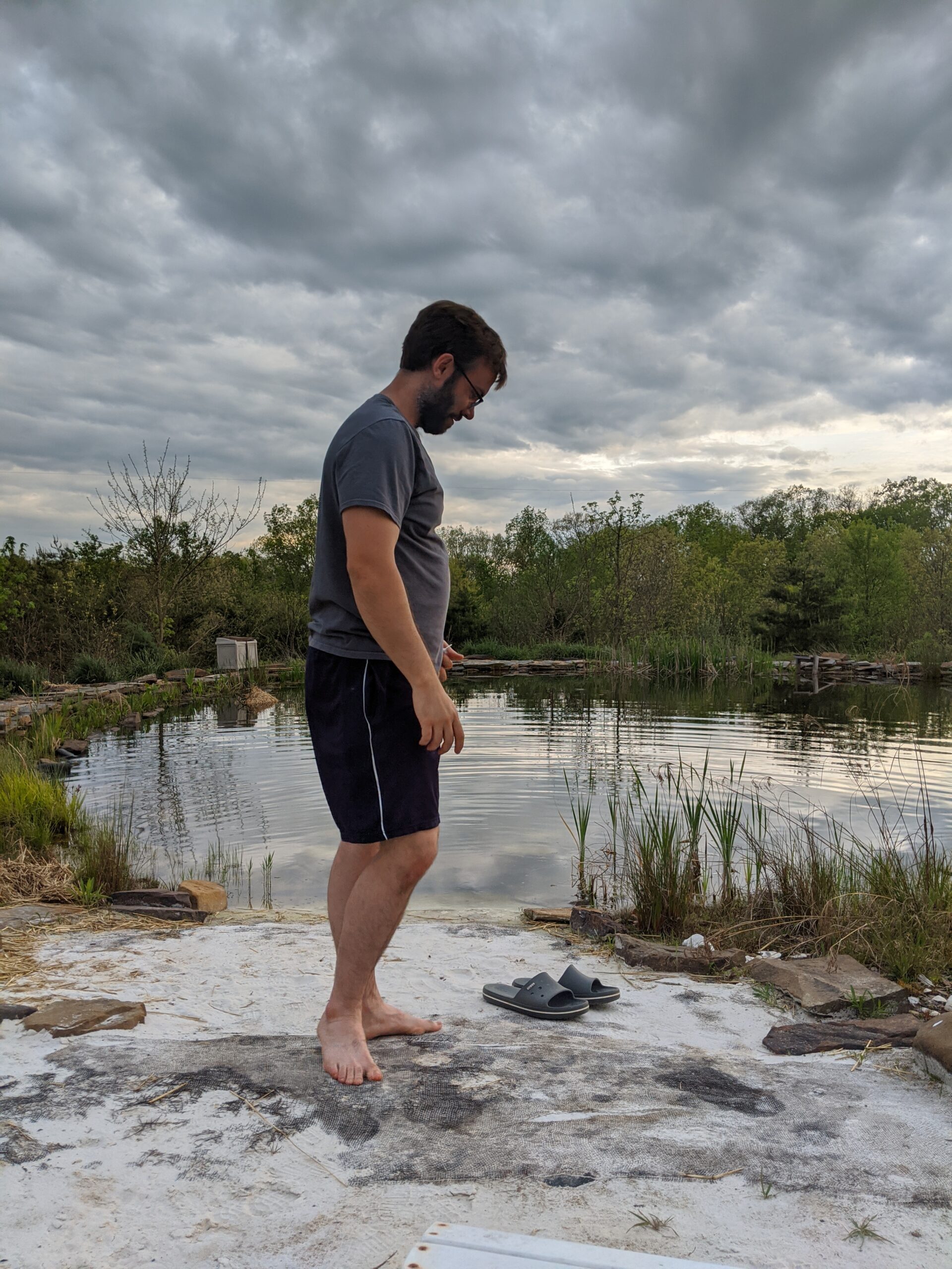 Bryan checking the health of his plants at the natural pool he and his family created