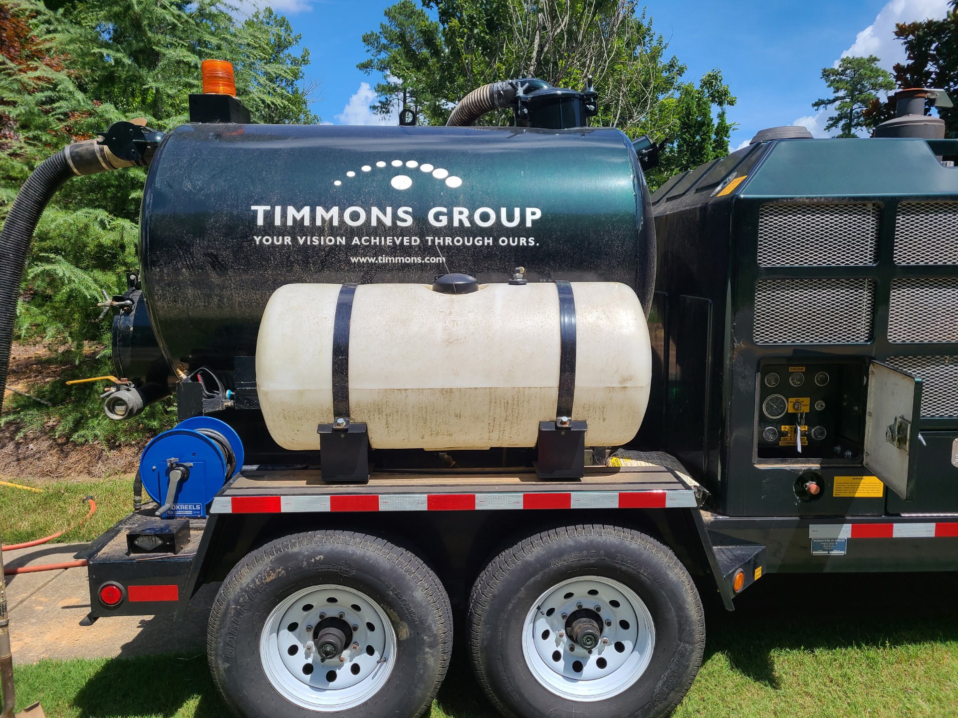 A Vacmaster trailer on wheels sports the Timmons Group logo.