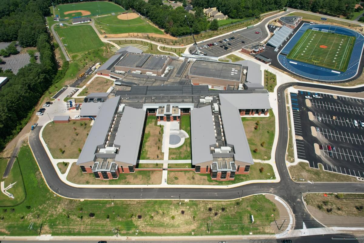 Above aerial photo of J.R. Tucker High School, featuring the school, football field with wrap around track, parking lot, and baseball field.