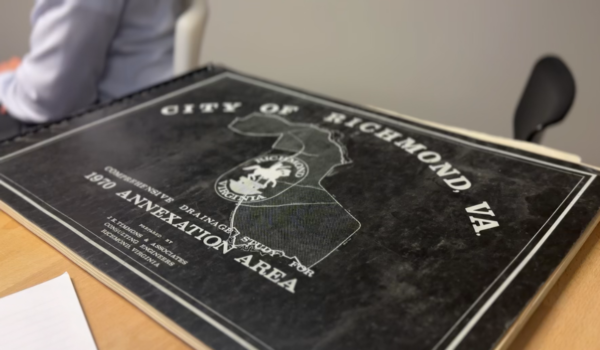 A black landscape booklet that reads in white text "City of Richmond, VA. Comprehensive Drainage Sudy for 1970 Annexation Area Prepared by J.K. Timmons & Associates Consulting Engineers Richmond, Virginia." In the middle is the old Richmond Virginia Logo and an outline of a parcel of land.