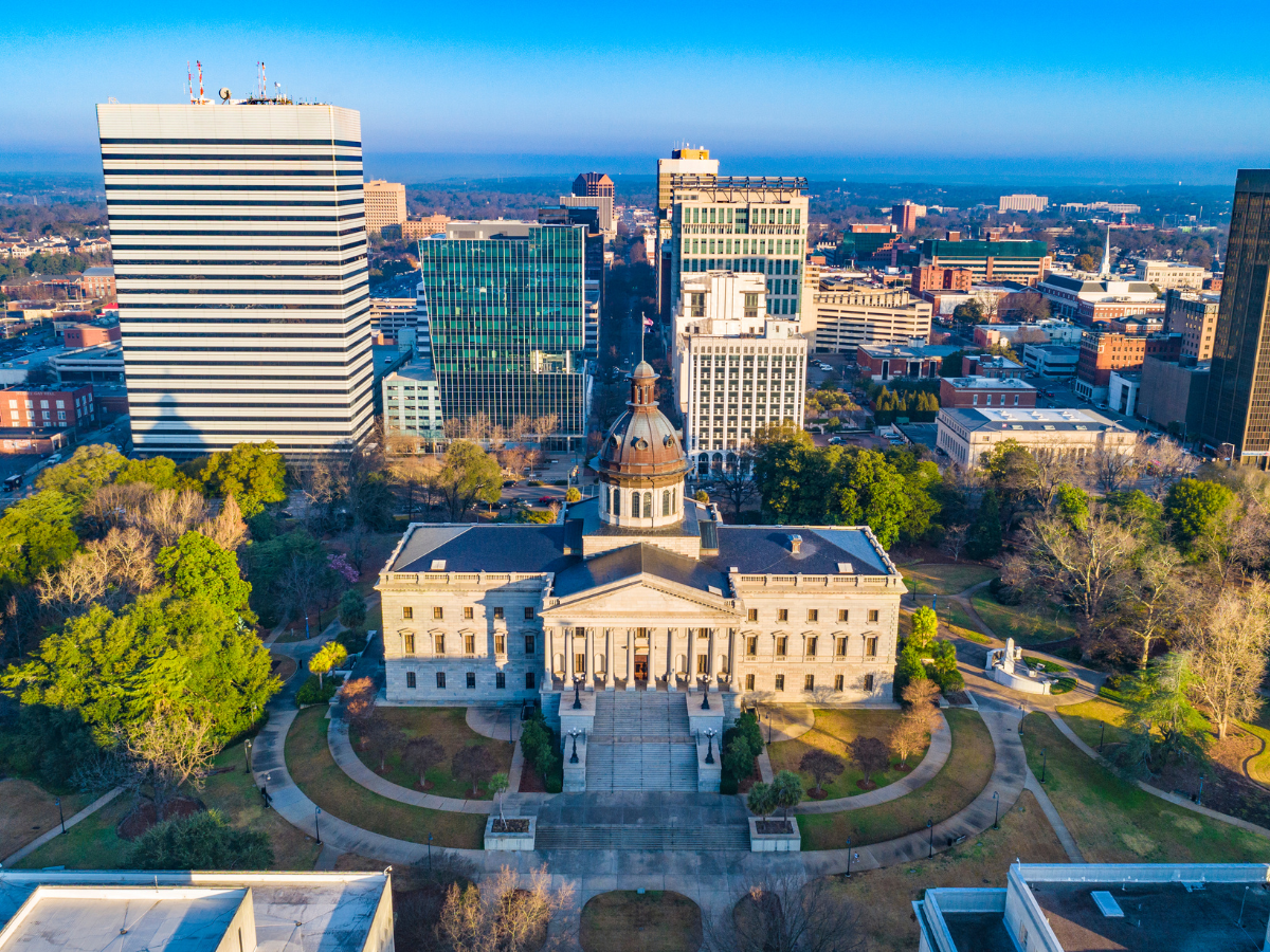 Aerial photo fo teh South Carolina State House surrounded by office buildings.