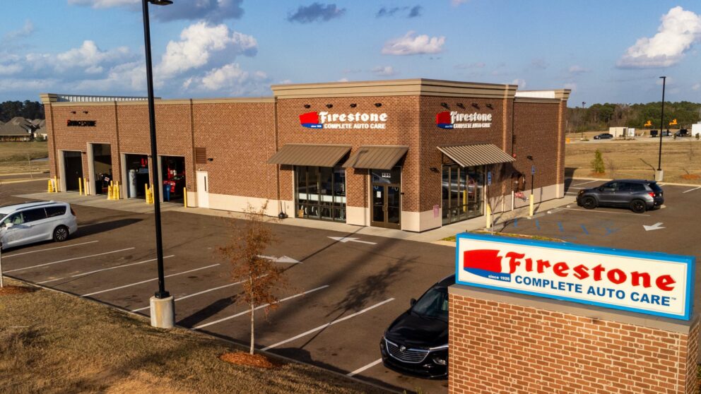 Front view of a Firestone tire and service center, showcasing the building's signage and entrance.